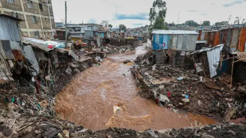 EPA People inspect damaged houses at an area flooded by the Gitathuru river water, a day after it overflowed and broke its banks due to heavy rainfall damaging surrounding neighborhoods, in the Mathare slums, Nairobi, Kenya, 25 April 2024