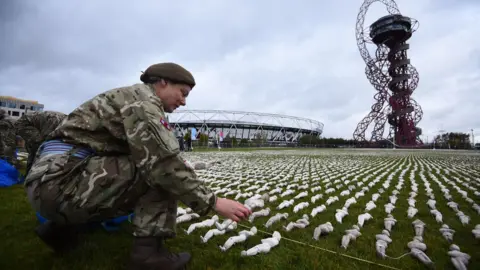 PA A soldier helps set out the Shrouds of the Somme