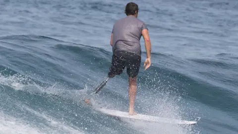 Chris Blowes Chris Blowes surfing with his prosthetic leg