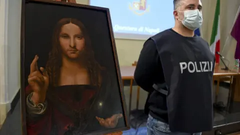 EPA Image shows a police officer stood next to the recovered painting