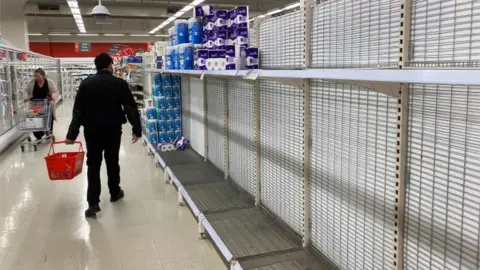 AFP A nearly empty toilet roll aisle in Melbourne