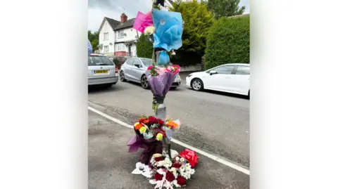 PA Wire Floral tributes at scene