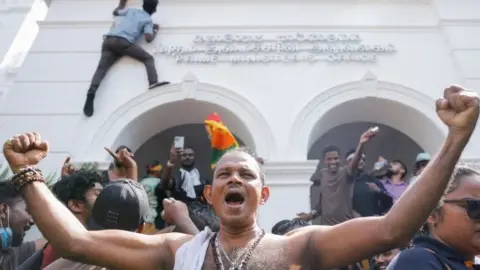 Reuters Protesters celebrate after entering PM's office