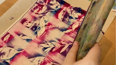 Rob Toomer A pink and blue artwork featuring a leaf design