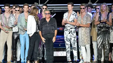 Getty Images Roberto Cavalli greets the audience at the end of his show for the Menswear Spring-Summer 2015 in Milan