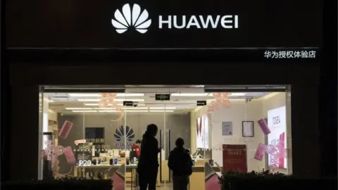 Getty Images Customers entering a Huawei Technologies store on 29 January, 2019 in Beijing, China