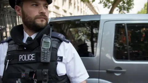 Getty Images Policeman with phone