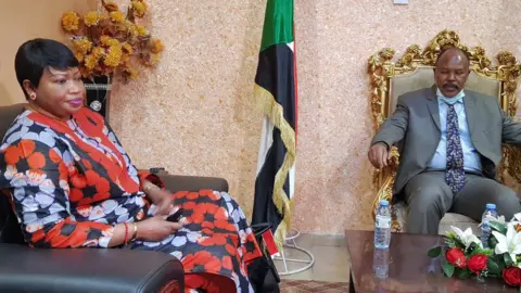 AFP Fatou Bensouda (L) meets the governor of Sudan's South Darfur state, Mousa Mahdi, on 31 May.