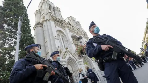 Reuters Police officers stand near the Notre-Dame basilica