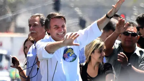 AFP File photo: Jair Bolsonaro gestures during a campaign rally