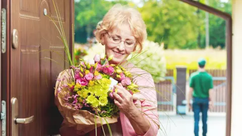 Getty Images Woman receives flowers