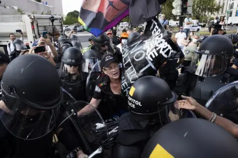 EPA US Capitol Police in riot gear surround a counter-protester