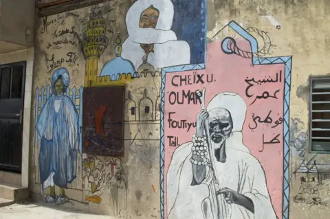 Alex Gorzen/Erica Kowal A mural in Dakar commemorates El Hadj Omar Saidou Tall