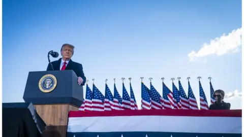 Getty Images Trump speaks before boarding Air Force One for the last time