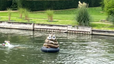 Little Blue Dot Poo model floating in river