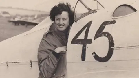 BWPA Sepia-coloured photograph of Freydis Sharland leaning out the cockpit of a Hawk Major aircraft with the number 45 painted on the side