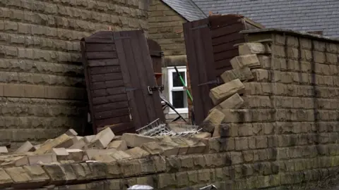 PA Media Screengrab taken from PA Video of a damaged gate in Stalybridge, following a "localised tornado" which damaged around 100 properties in Greater Manchester