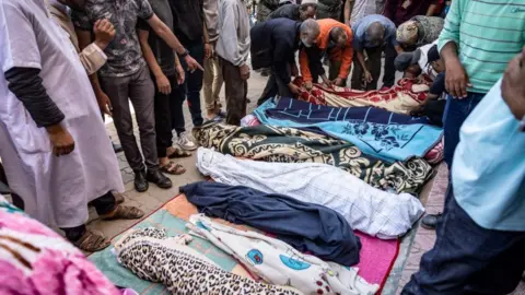 Getty Images Relatives mourn in front of the bodies of victims killed in the earthquake in Moulay Brahim, in al-Haouz province