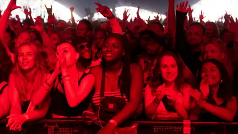 AFP The audience for Nigerian Rema on the Arena Stage cheer on the grounds of Roskilde Festival 2023 - Denmark, June 2023