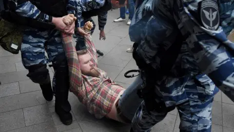 Getty Images Police carrying a man away