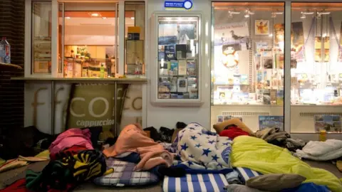 EPA Migrants sleep Flensburg railway station in Germany on their way to seeking asylum in Denmark - 2015