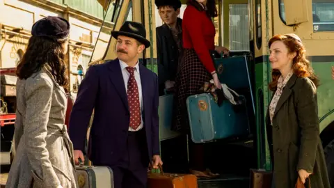 BBC/Eleven/John Platt Kate (MICHELLE KEEGAN), Terry (WARREN BROWN) and Annie (FAYE MARSAY) in scene outside a bus