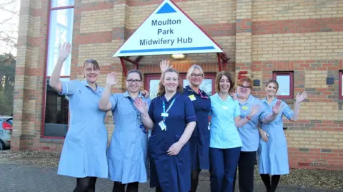 Northampton General Hospital NHS Trust Midwives in blue uniform stand outside new hub