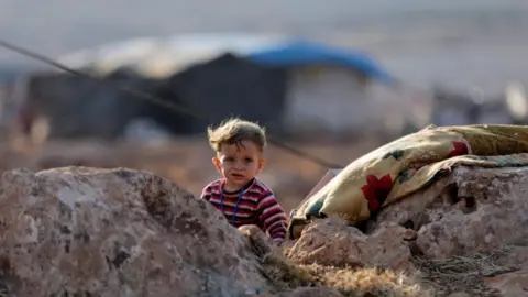 Reuters A newly displaced Syrian child near a refugee camp in Atimah village, Idlib province