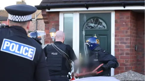 Merseyside Police Police smash door