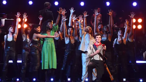 Getty Images Dónal Finn and Melanie La Barrie of Hadestown perform on stage with other cast members during The National Lottery's Big Night of Musicals