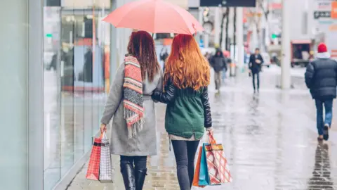 Getty Images Shoppers in the rain