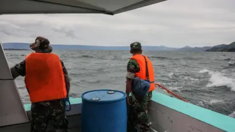 EPA An Indonesian search-and-rescue team looks for victims of a sunken ferry on Lake Toba in Indonesia, 19 June 2018