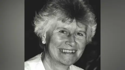 A black and white image of Beryl Purdy smiling