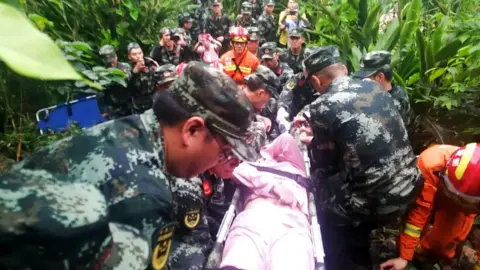 EPA Sichuan police carry an injured person to a medical aid point in Changning county, Yibin city, Sichuan province, 18 June 2019