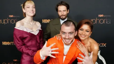 Getty Images Hunter Schafer, Sam Levinson, Angus Cloud, and Zendaya at Euphoria's Season 2 Photo Call