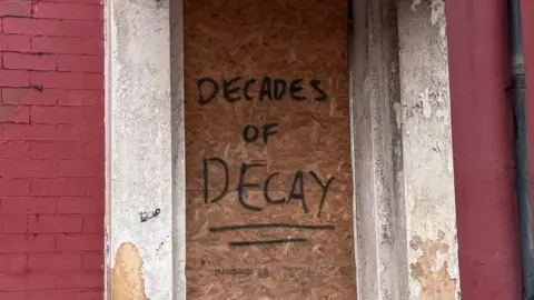 BBC Graffti reading "Decades of decay" on a building near Central Pier in Blackpool