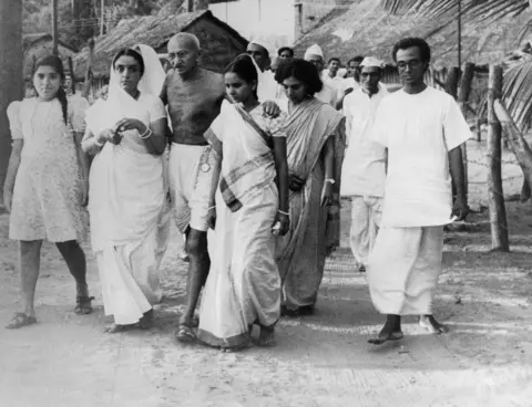 Getty Images Gandhi on his way to a prayer gathering in Mumbai in May 1944.