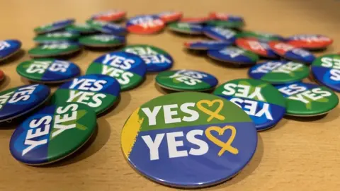PA Media Yes badges at an event in Dublin
