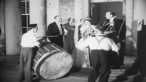 Pathé  Pathe footage of the Queen and the Duke of Edinburgh as the drummers play