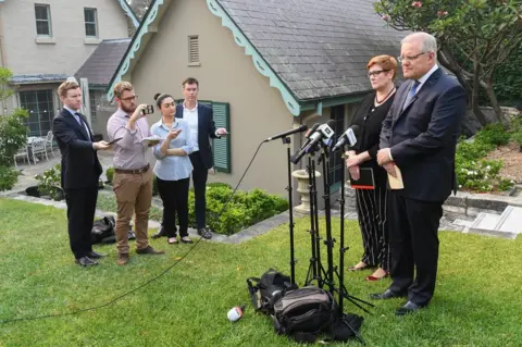 Getty Images Australian Prime Minister Scott Morrison addresses the media with Foreign Minister Marise Payne