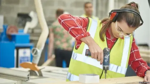 Getty Images Woman drilling in workshop