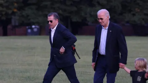 Reuters Hunter Biden and U.S. President Joe Biden, holding the hand of his grandson Beau Biden Jr