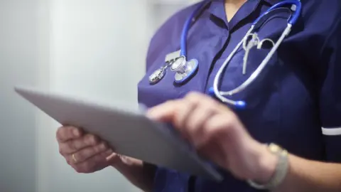 Getty Images Doctor with an iPad