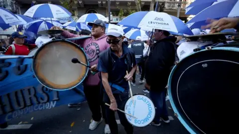 Reuters A man plays a drum during protests against university cuts in Buenos Aires.