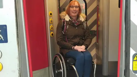 Rail Delivery Group Wheelchair user Sarah Ward on a train