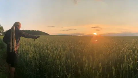 Paul Cheese Paul records barley field as sun sets in Shropshire