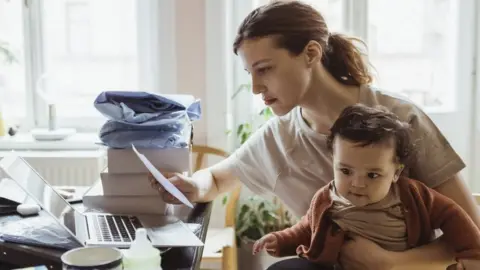 Getty Images Woman looking a energy bill