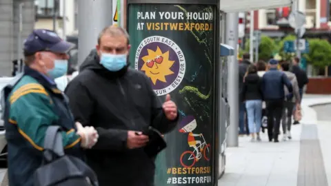 PA Media People wearing masks in Dublin