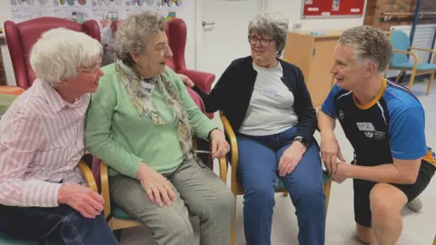 Nikki Fox/BBC (from left to right) Pat Lade, Irene Park and Pat Hankin talk to the exercise class instructor