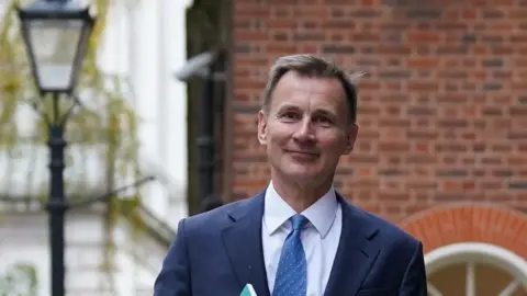 Reuters Chancellor Jeremy Hunt seen walking along Downing Street